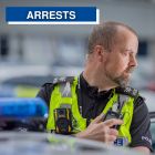 Arrest graphic showing officer stood at police car
