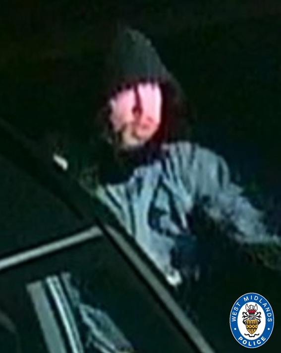 CCTV image of man in a dark coat and black hood pulled up over head