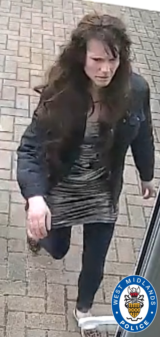CCTV image of woman with long brown hair and wearing a black jacket and grey dress with black leggings