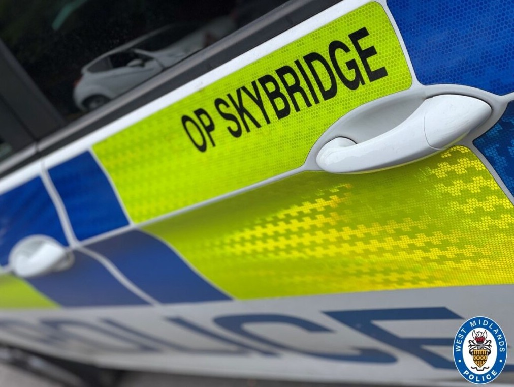 An Op Skybridge marked police cars