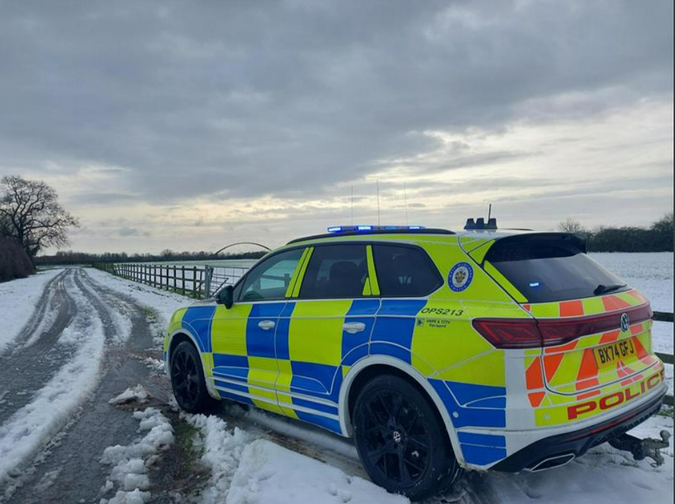 A snowy scene with a police car