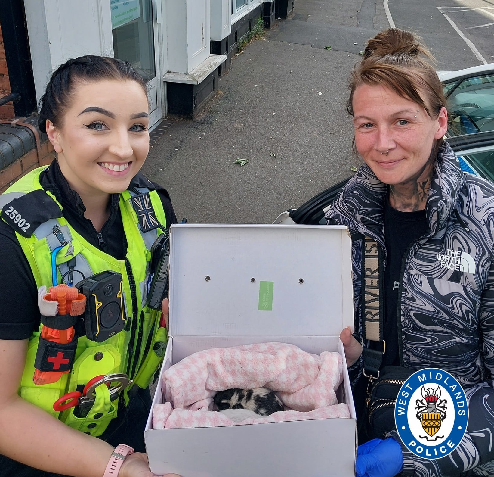 image of officer and Tammy with kittens in a box