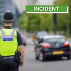 Image showing male PC on side of road with car in background with incident wording on side of graphic
