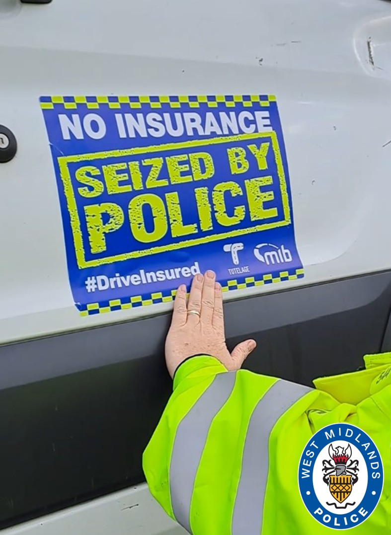 No insurance sticker being placed on vehicle by officer