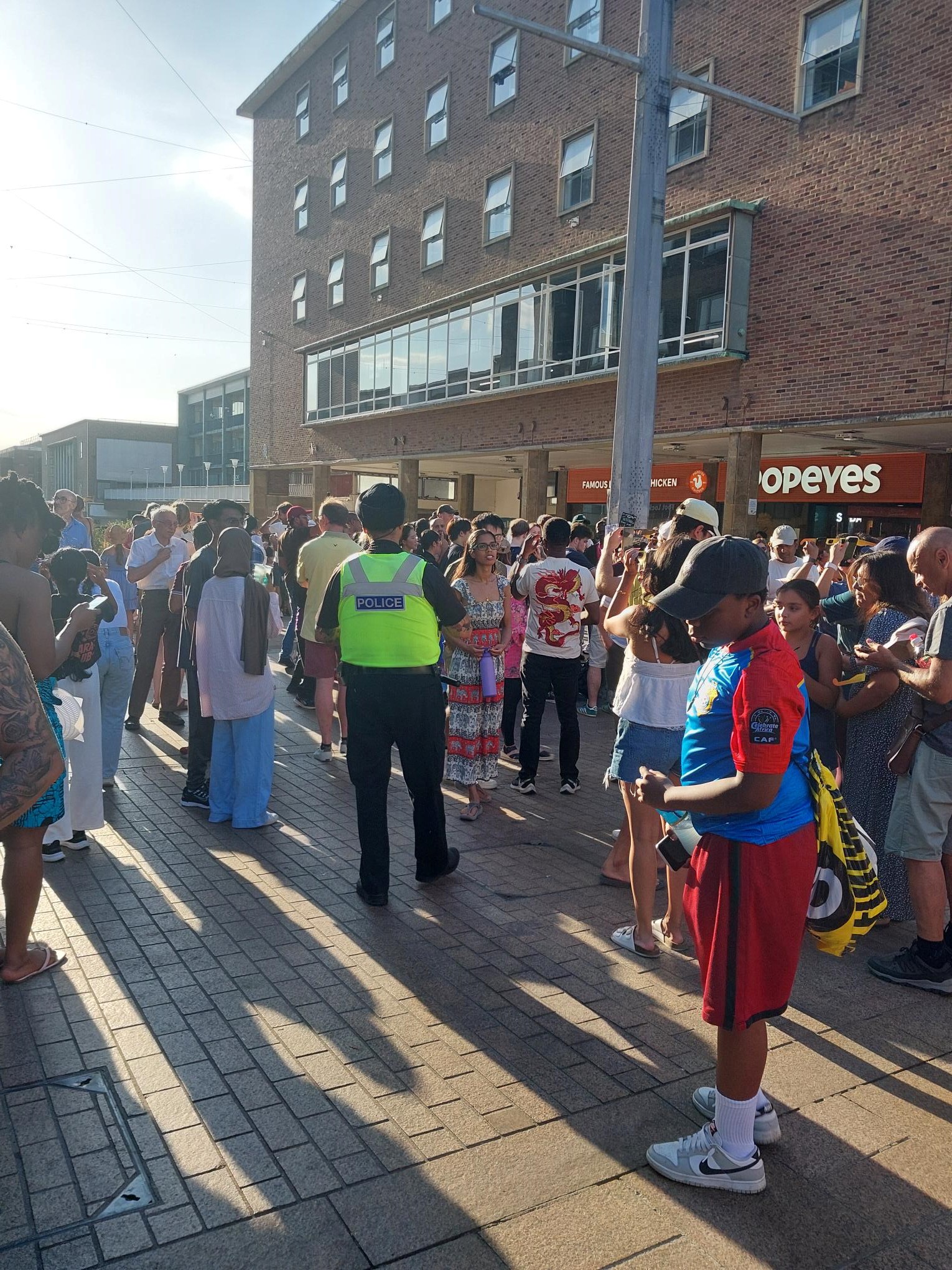 police officer with crowd of people