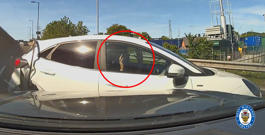 Joshua Jones is seen with his hands up after officers make contact with his car