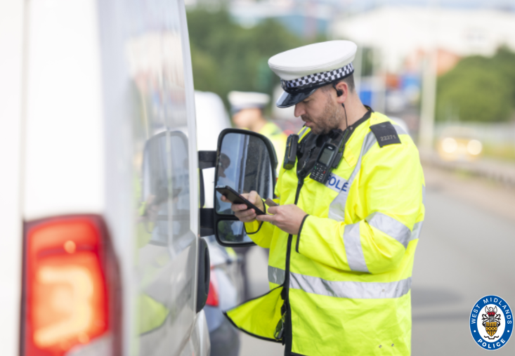 officers speaking to van driver