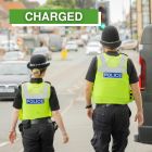 Two police officers on patrol with a police van and text box saying "charged"